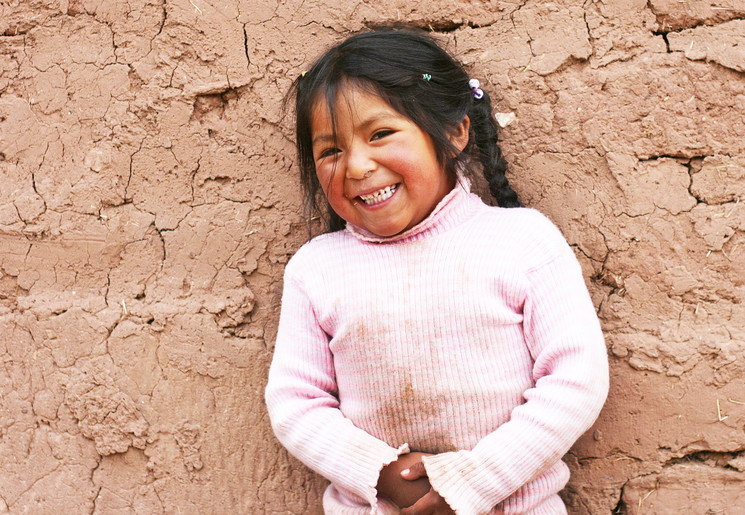 Vrolijk meisje in het authentieke dorp Guamote