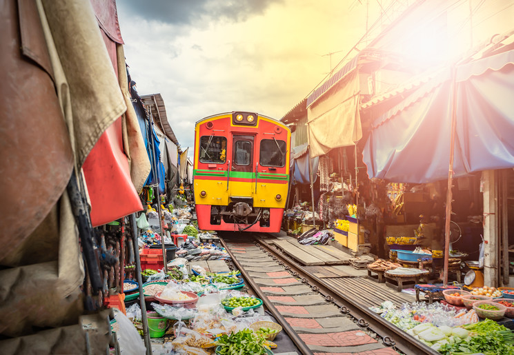 Trein rijdt langs de Mae Klong markt bij Bangkok, Thailand